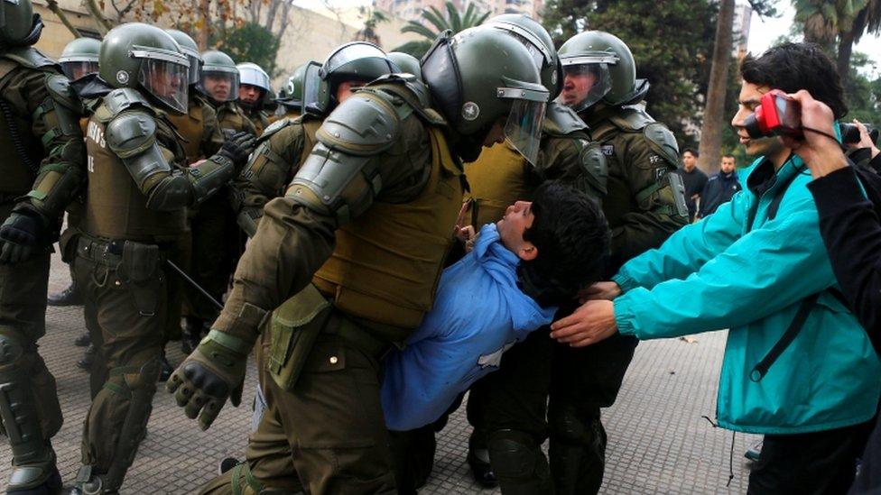 Police grabs student during demonstration in Santiago