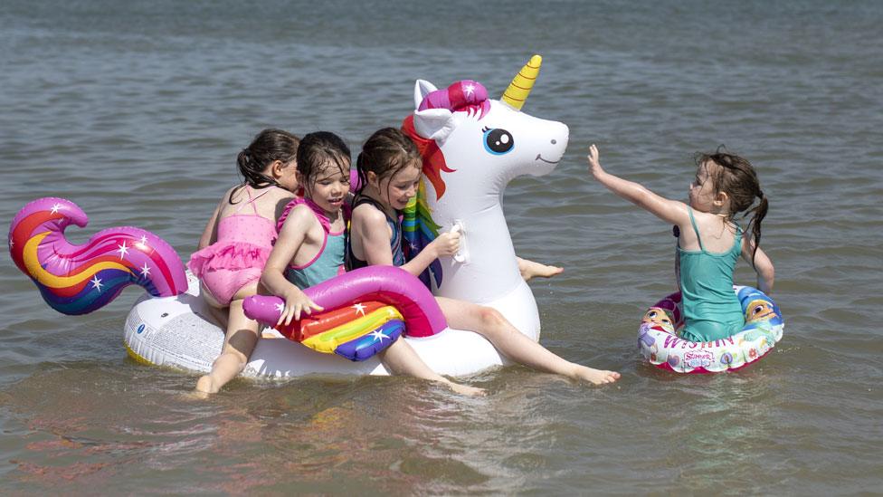 Children play in sea