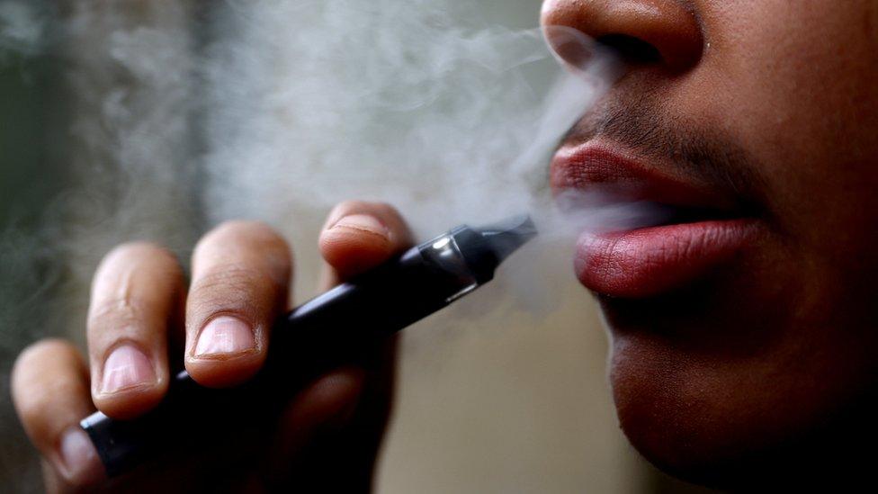 A man smokes a disposable vape, Newcastle-under-Lyme, Britain.