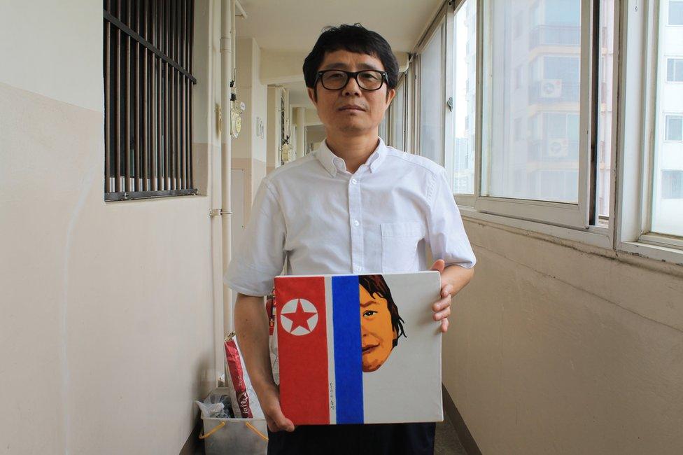 Song Byeok holds up one of his North Korean propaganda pieces