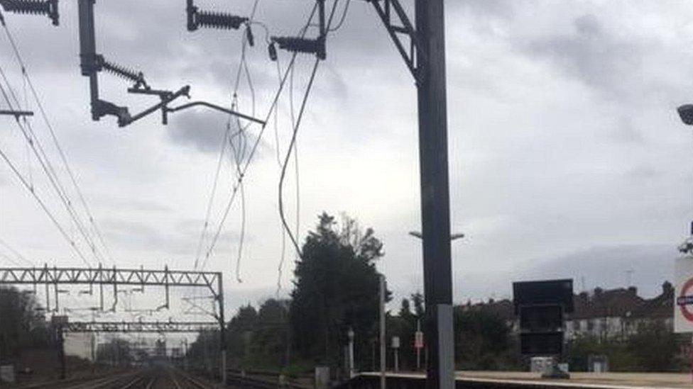 Damaged cables on wooden poles in a countryside setting