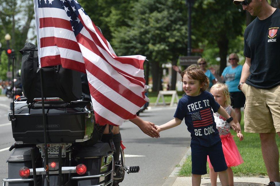 Biker fives a young spectator