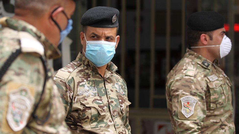 Iraqi security forces wear masks in central Baghdad on 5 May 2020