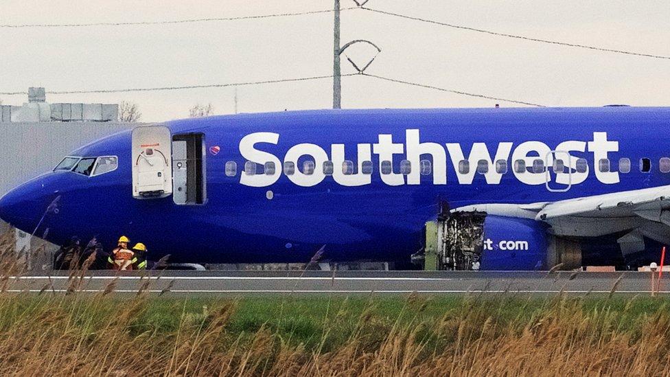 Emergency personnel monitor the damaged engine of Southwest Airlines Flight 1380, which diverted to Philadelphia International Airport. 17 April 2018