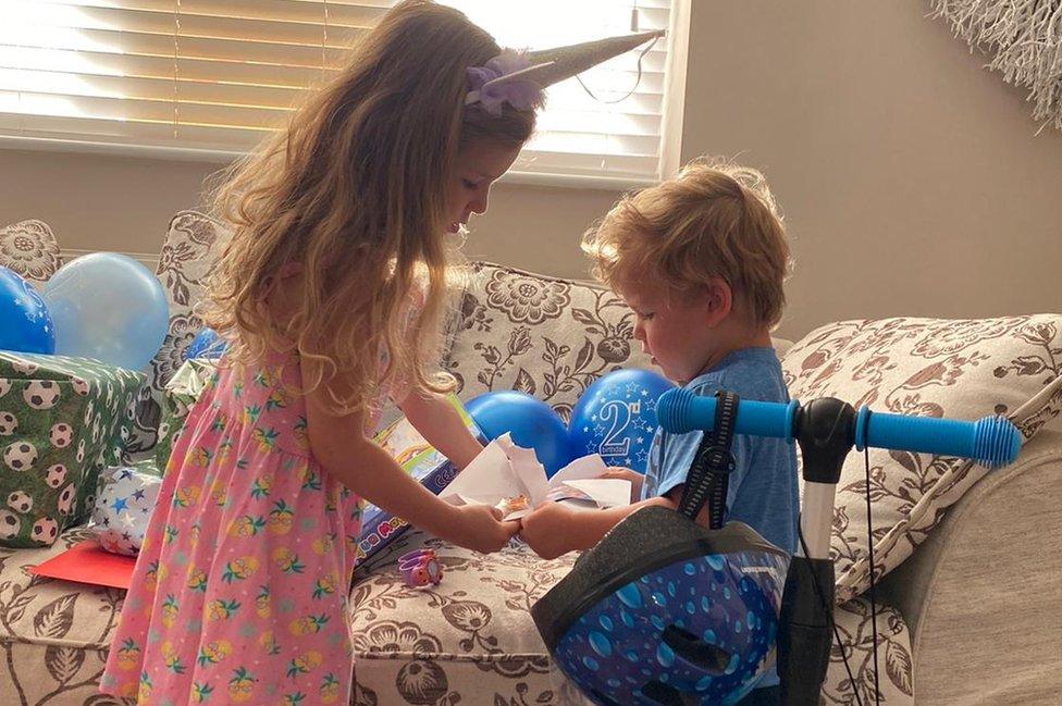 the two children opening presents