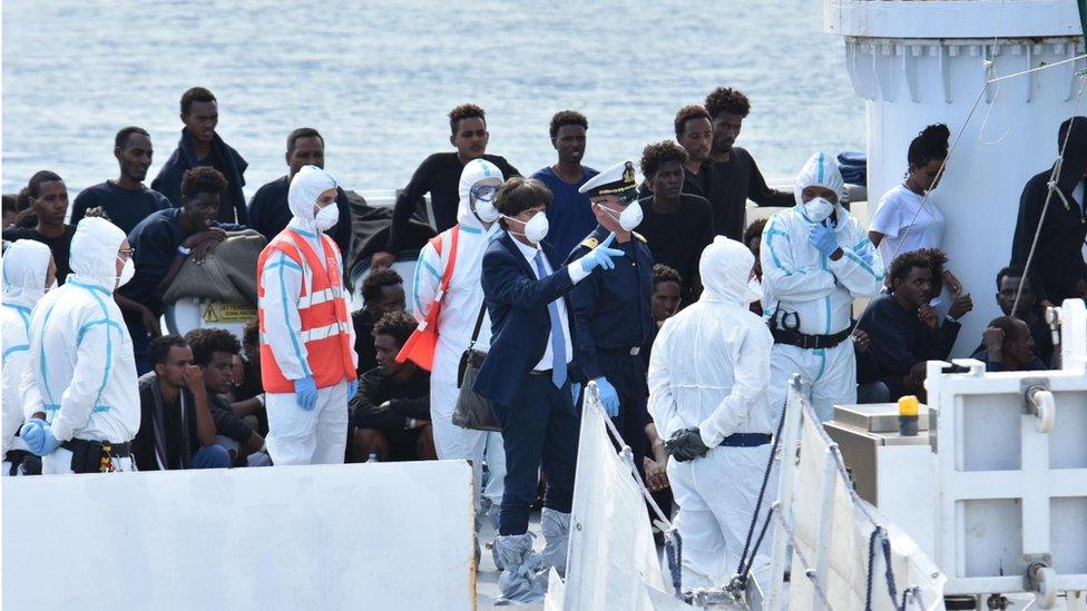 The prosecutor of Agrigento, Luigi Patronaggio (c), waits to get on board of the ship Diciotti in Catania