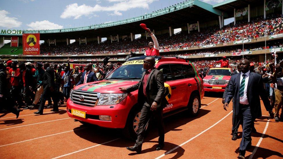 Kenya's President Uhuru Kenyatta waves to supporters as he arrives at the Kasarani stadium for the official launch of the Jubilee Party ahead of the 2017 general elections in Kenya's capital Nairobi, September 10, 2016.