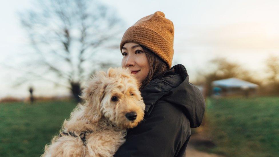 Woman hugging her dog