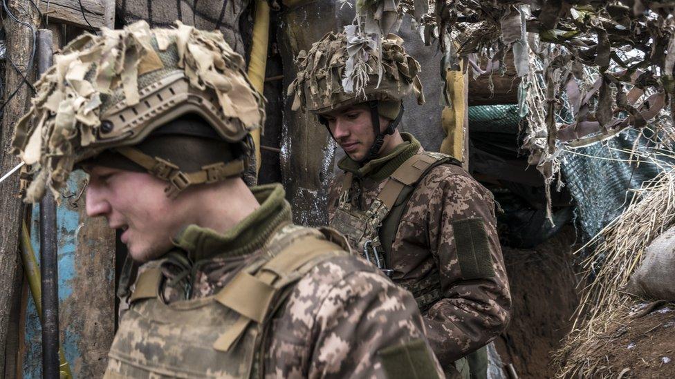 Ukrainian soldiers walk in a trench near the front line on January 17, 2022 in the village of New York, formerly known as Novhorodske, Ukraine.