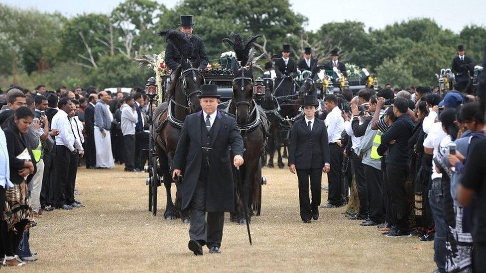 Five coffins are taken by horse drawn carriages to the crematorium after the funeral on Winn's Common Park