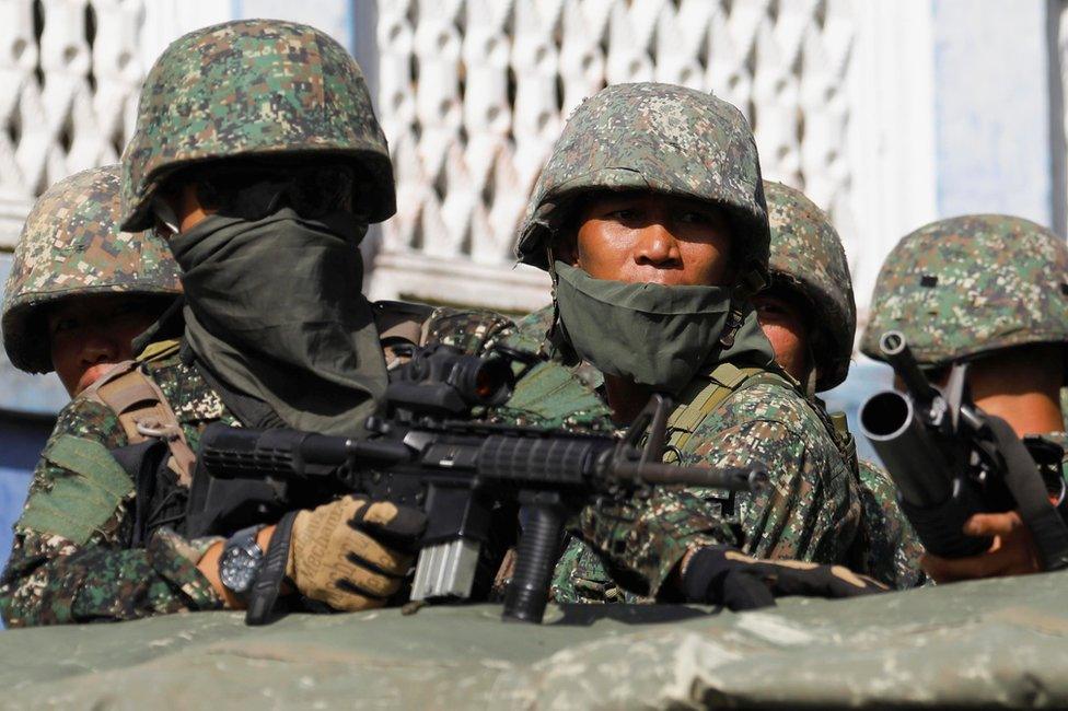 Members of Philippine Marines are pictured aboard a vehicle as more soldiers reinforce to fight the Maute group in Marawi City in southern Philippines 29 May 2017.