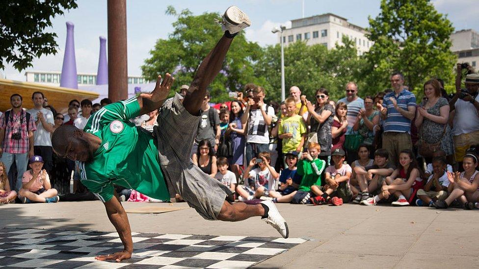 Break dance group One Motion Crew perform for money to a busy crowd of tourists on the South Bank, London