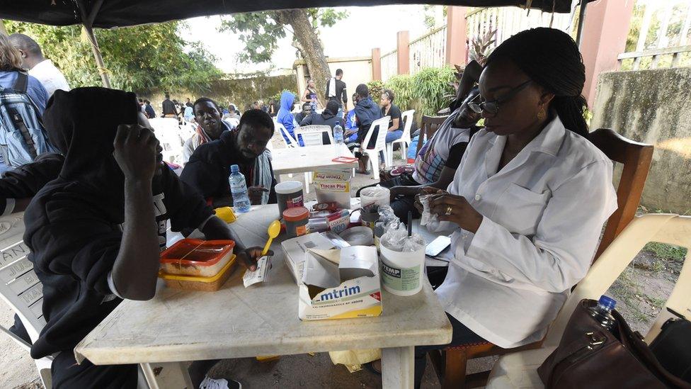 Migrants see health officials shortly after returning from Libya in Benin City, Nigeria