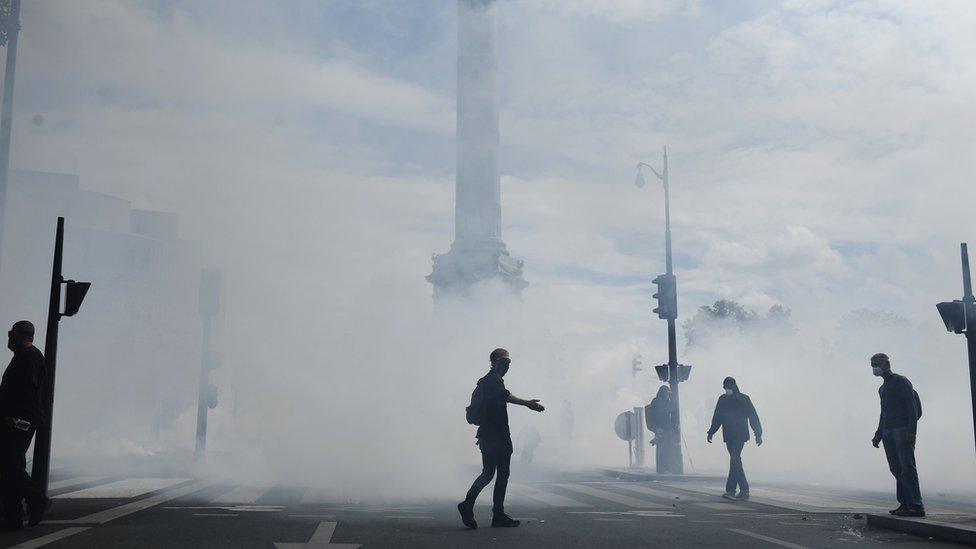 Riot police using tear gas