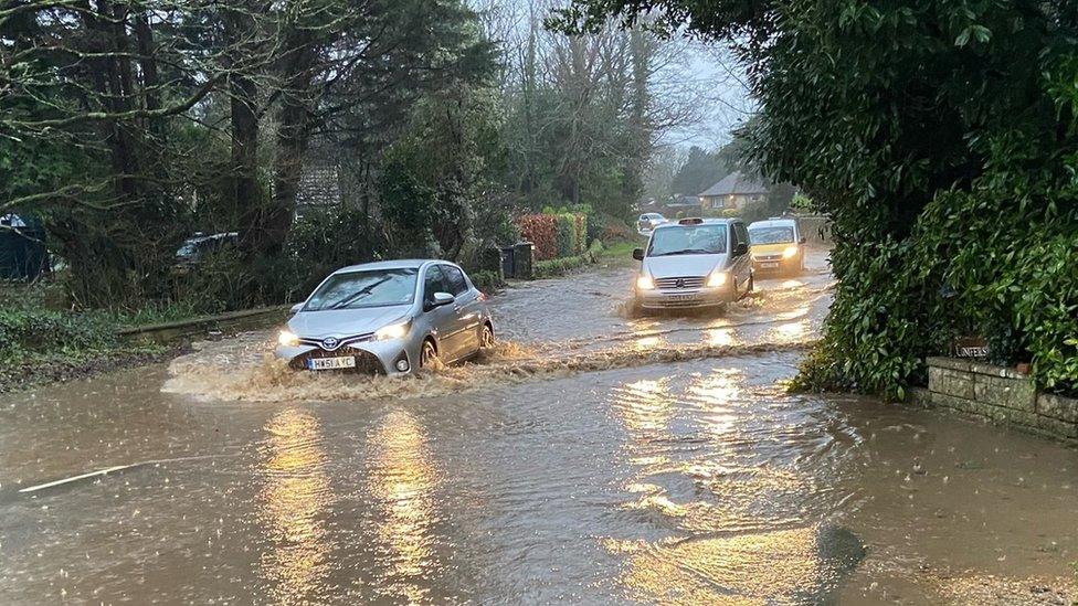 Cars drive through flood water on the Isle of Wight