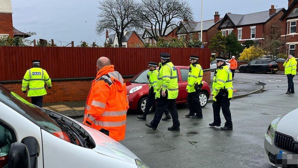 Police in attendance as residents blockade a road in Southport