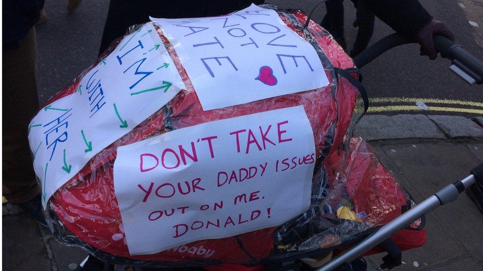 A baby's pram with slogans attached