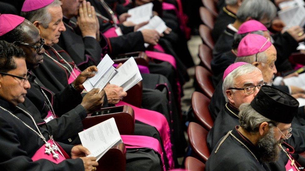 Bishops reads books at a meeting of the synod