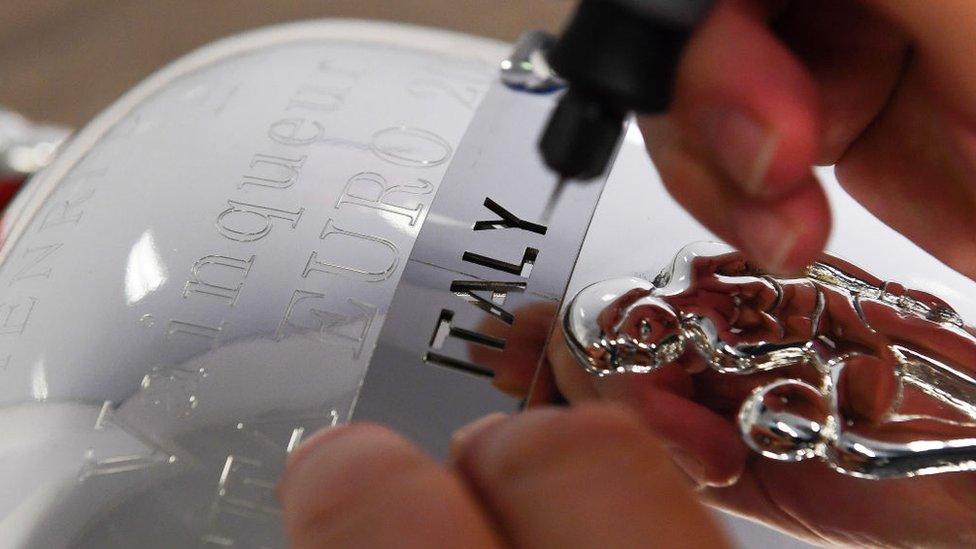 Euro 2020 winners Italy having their name engraved on the Euro trophy