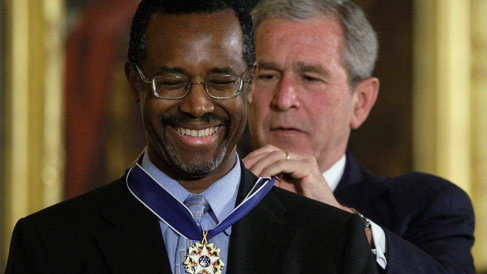 U.S. President George W. Bush (R) presents a Presidential Medal of Freedom to Benjamin S. Carson, Sr. M.D (L), for his work with neurological disorders during an East Room ceremony June 19, 2008