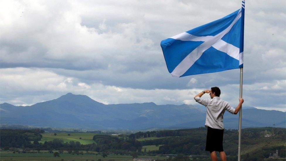 Man holding Saltire