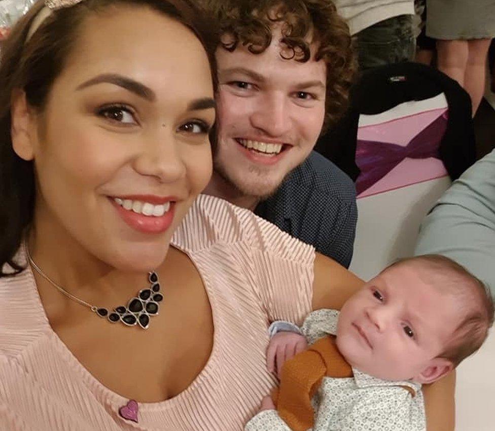 Amanda Lewis with her partner and child