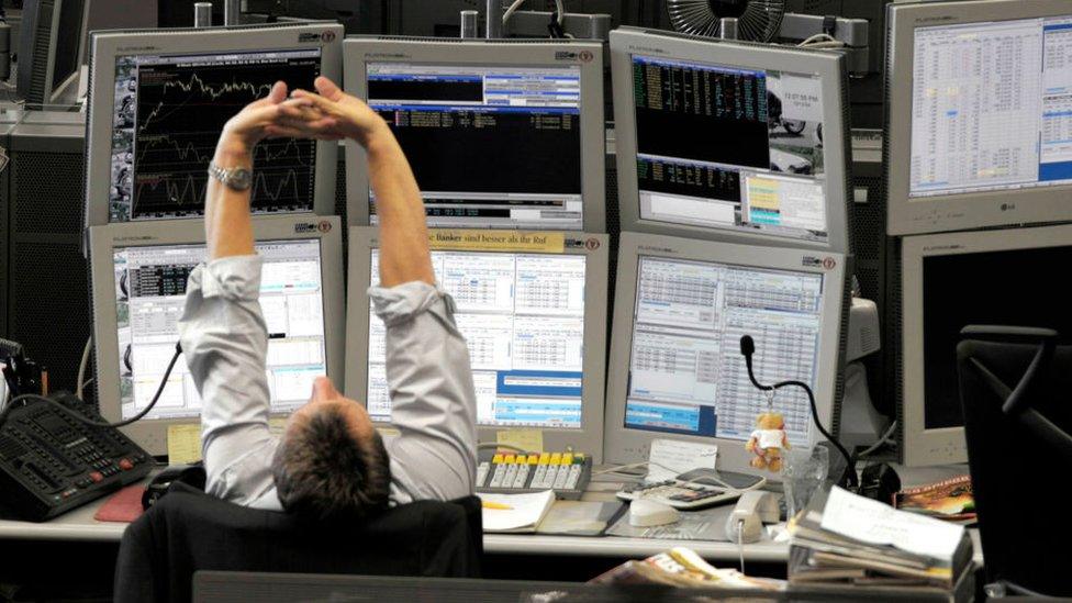 Banker stretching at desk