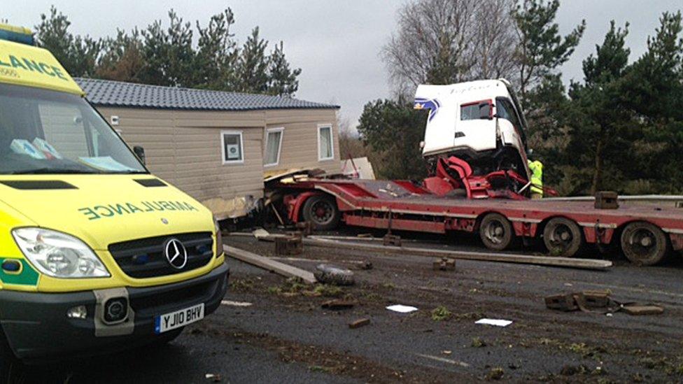 Wreckage of a crashed lorry with debris on the motorway