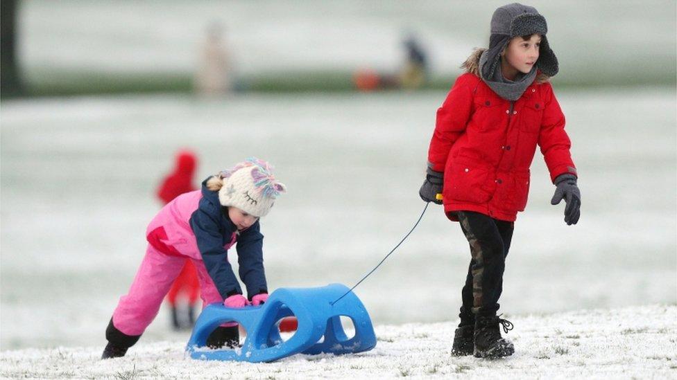 Daniel, 8, is sledging with his sister in Liverpool