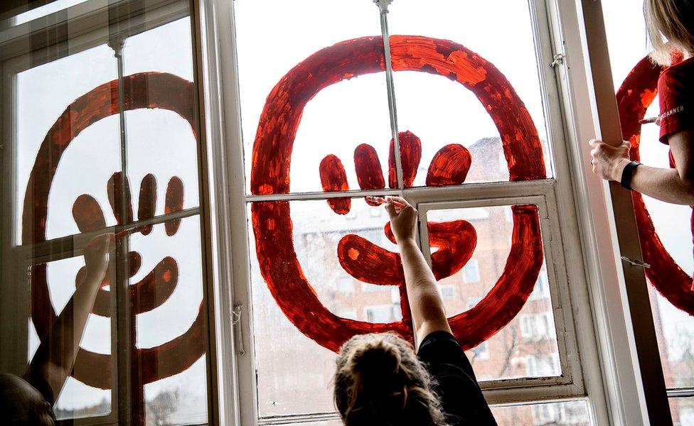 Women painting windows for International Women's Day in Copenhagen