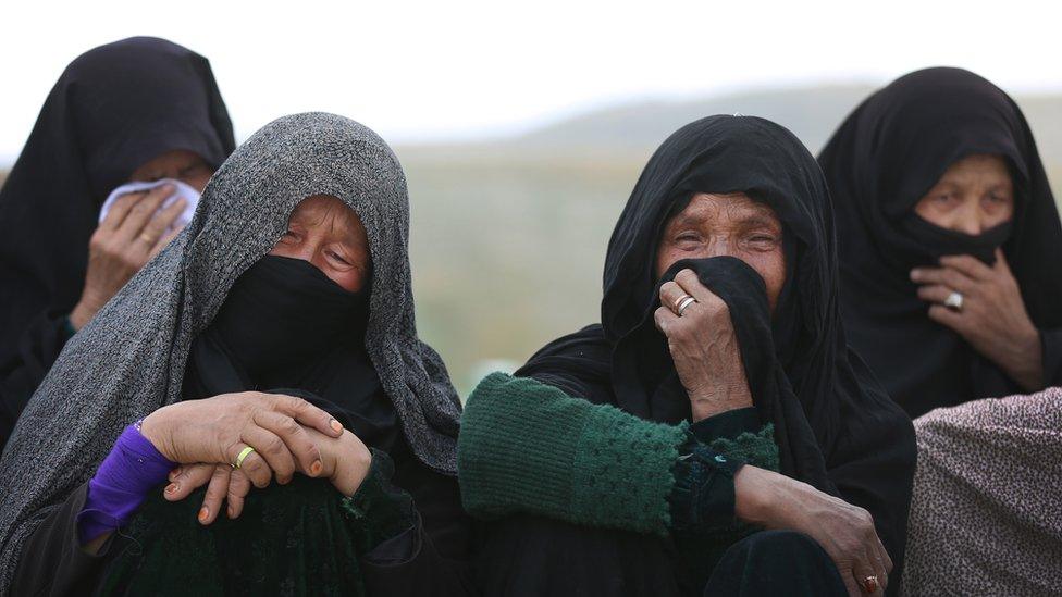 Relatives mourn at the funeral of a pregnant woman killed in the attack