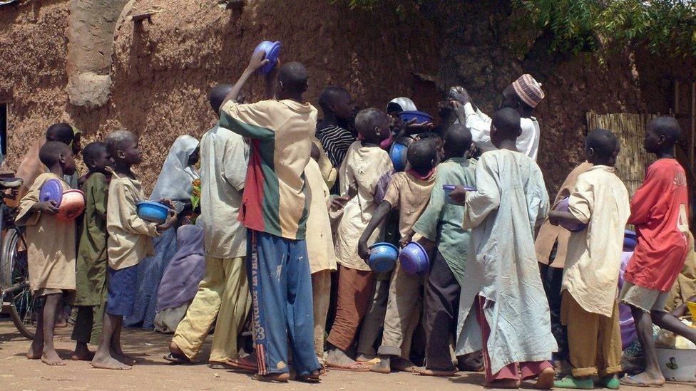 A crowd of child beggars struggle for alms from a man in northern Nigeria's Kano city (file photo)