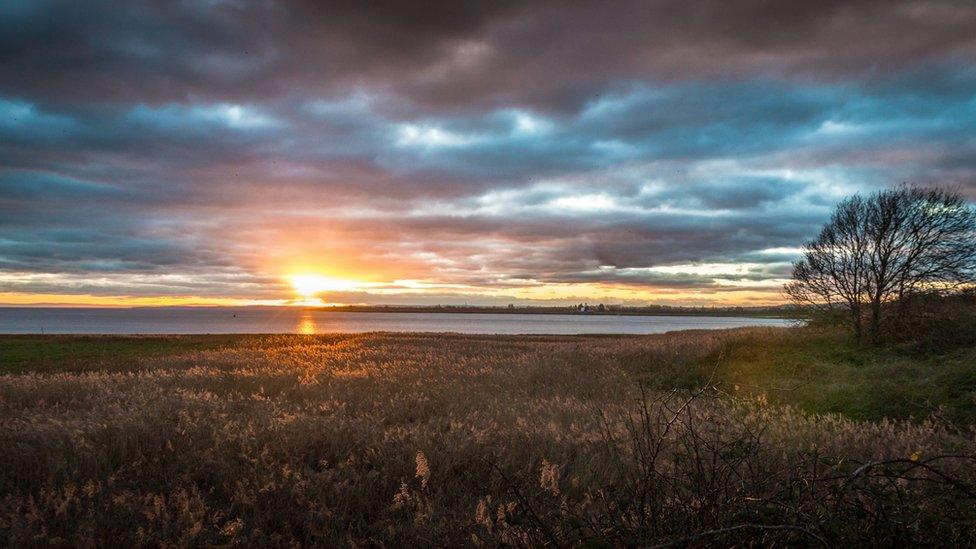 A moody sunset over the Usk Estuary at Newport Wetlands