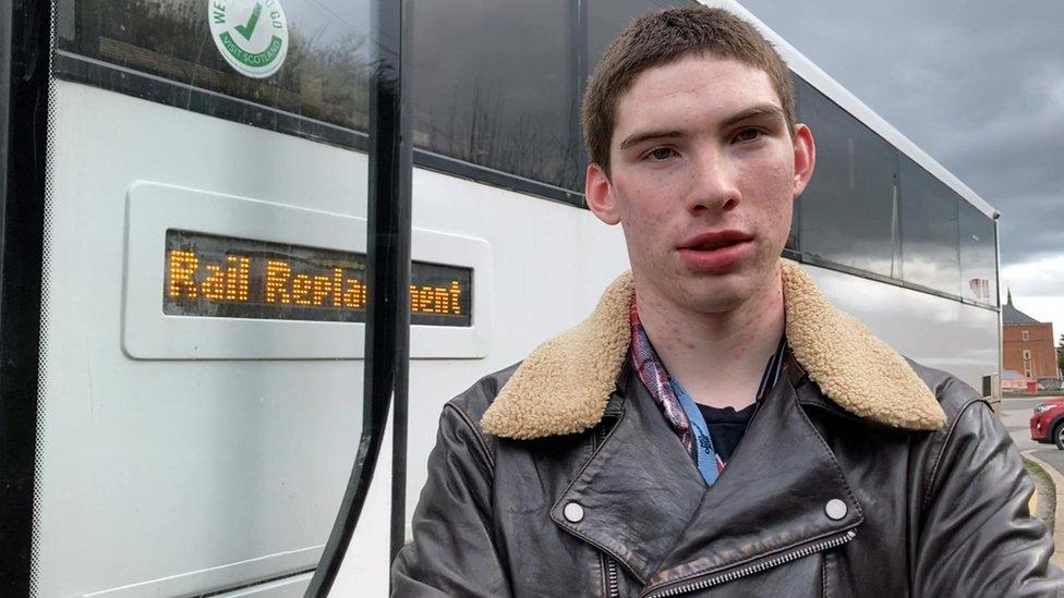 Harry Mawdsley standing in front of a rail replacement bus