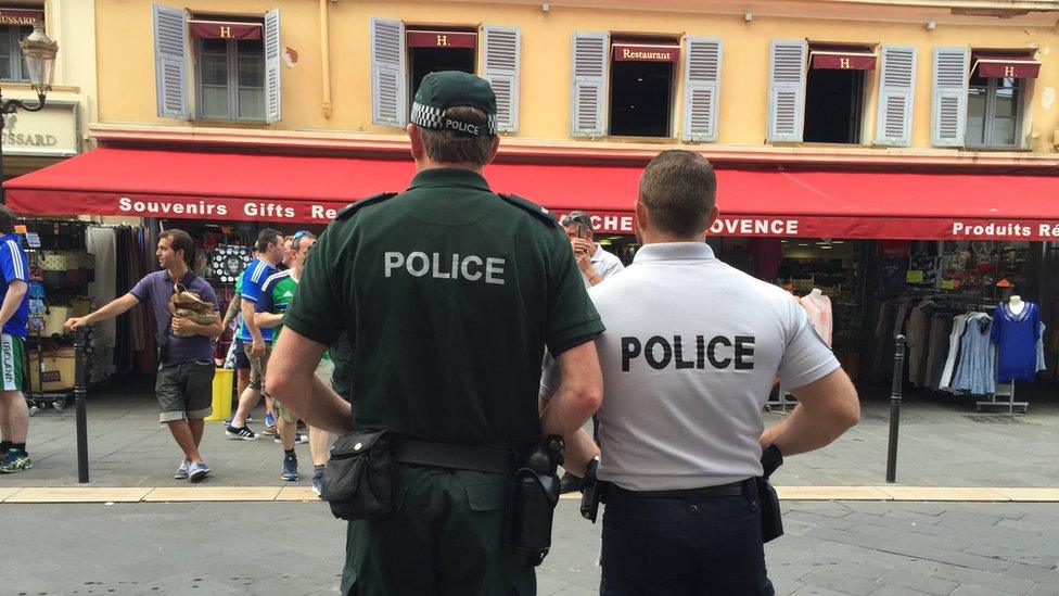 A police officer from Northern Ireland with a police officer from France