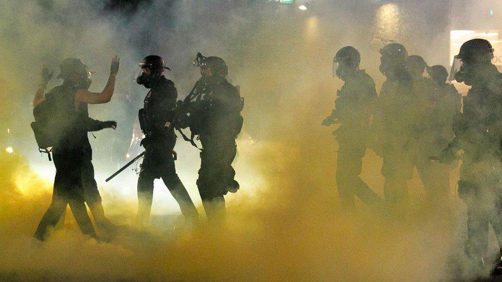 Police confront demonstrators as Black Lives Matter supporters demonstrate in Portland, Oregon on July 4, 2020