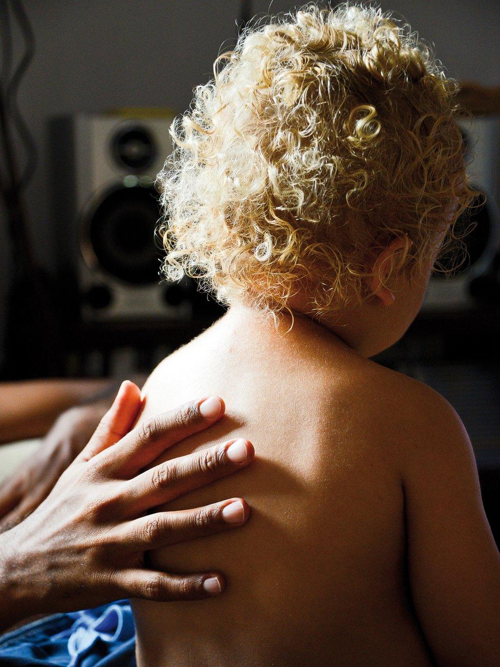 Hand on child's back