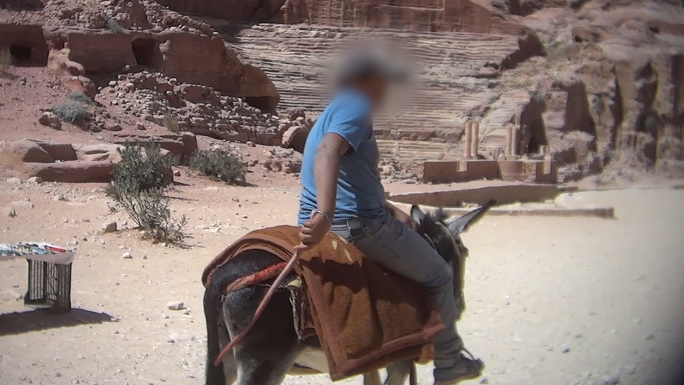 A man rides a donkey at Petra