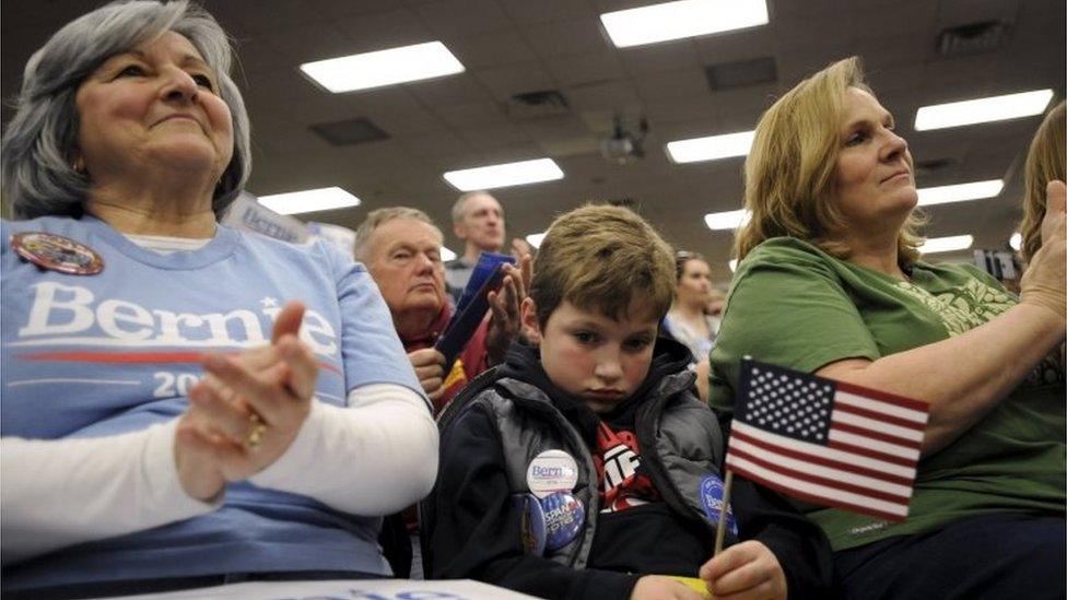 Tucker Dunn (C), 7, listens as U.S. Democratic presidential candidate Bernie Sanders speaks at a campaign rally in Waterloo, Iowa January 31, 2016