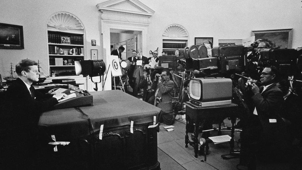 President Kennedy, shown discussing Cuba with reporters