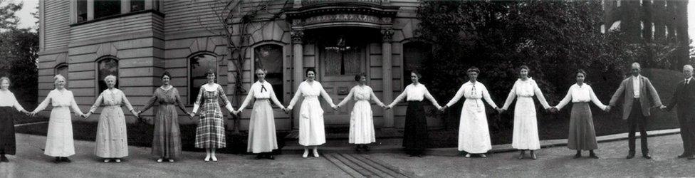 A dozen women computers hold hands in this 1918 photograph, which Smith Zrull calls the "paper doll" photo. To the far right is Edward Pickering, who hired the women computers.