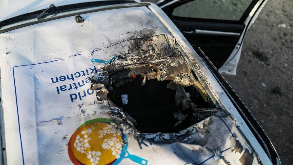 A destroyed car of the NGO World Central Kitchen (WCK) sits along Al Rashid road