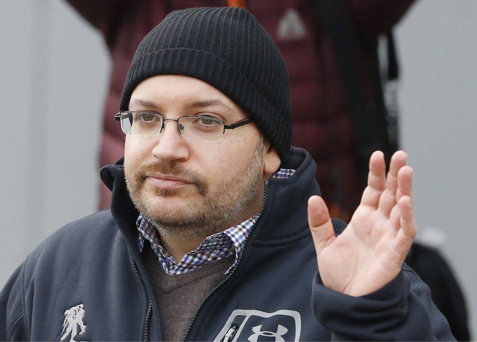 Journalist Jason Rezaian waves as he poses for journalists in front of Landstuhl Regional Medical Center in Landstuhl, Germany on 20 January, 2016 after being released from prison in Iran