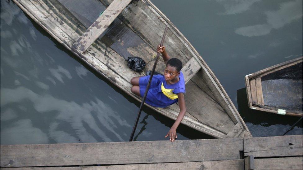 A student arrives at a floating school on a canoe in the Makoko fishing community on the Lagos Lagoon, Nigeria, in photo released on 4 March