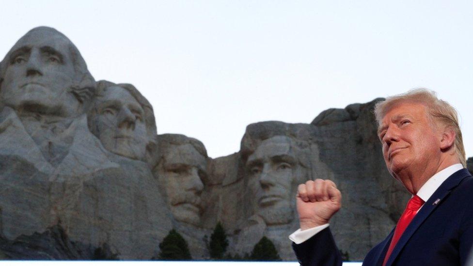 President Trump stands in front of Mount Rushmore