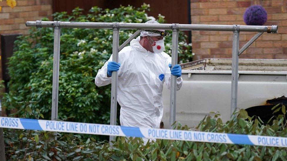 Forensics officers taking in equipment to the house in Milton Keynes being searched