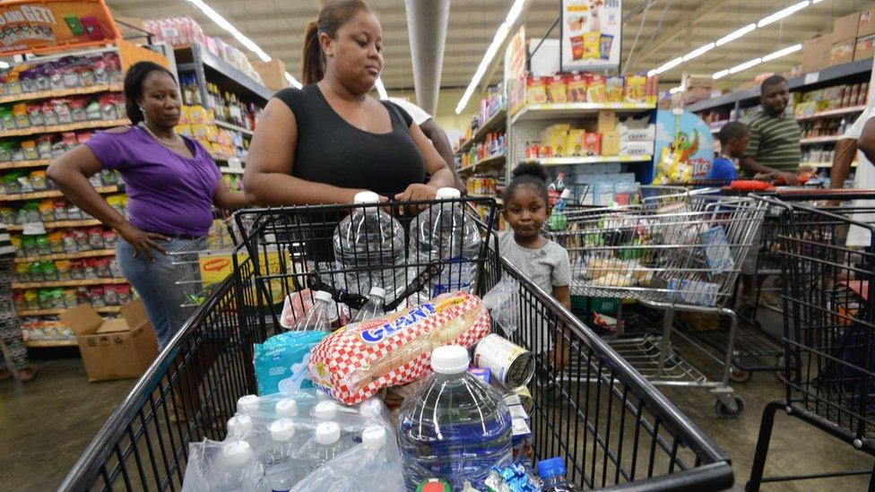 People buy groceries and supplies before the arrival of Hurricane Matthew in Portmore, Jamaica on 1 October