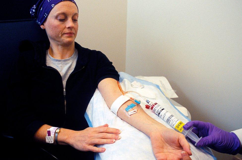 Cancer drugs are injected into a woman