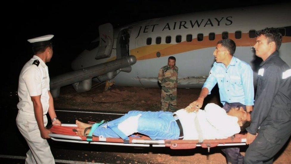 An injured person being carried on a stretcher after the plane skidded off the runway at takeoff at the Dabolim Airport in Goa (27 December 2016)