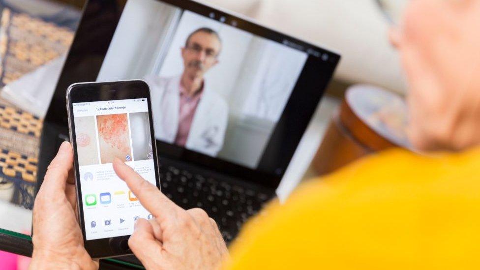 An elderly woman teleconsulting with a doctor from home